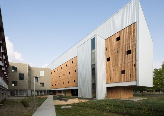 a building with a path and grass