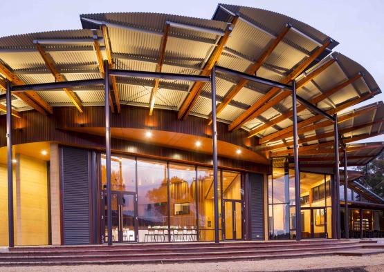 a building with a roof and glass doors