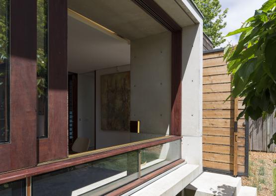 a building with a glass wall and a wooden fence