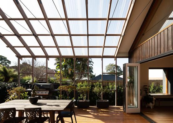 a room with a glass roof and a table and chairs