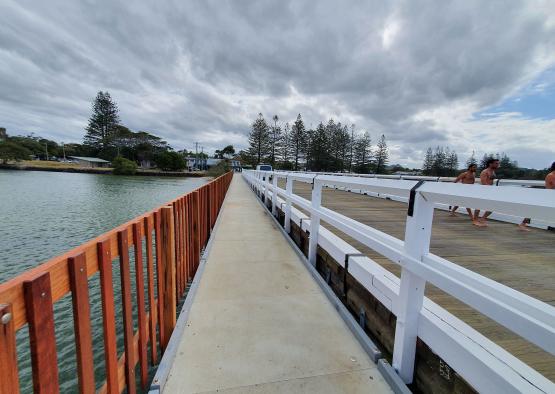 a walkway over water with a railing