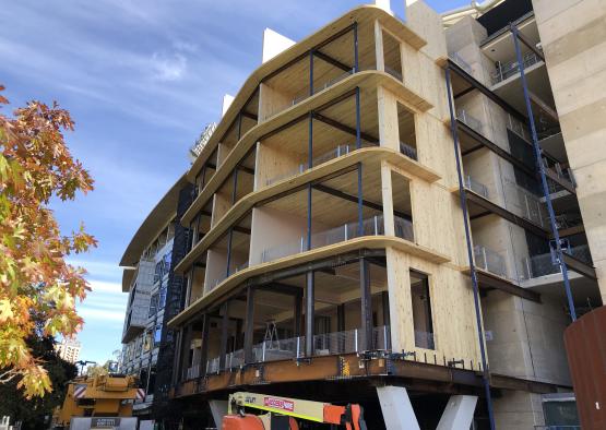 a building with balconies and a crane