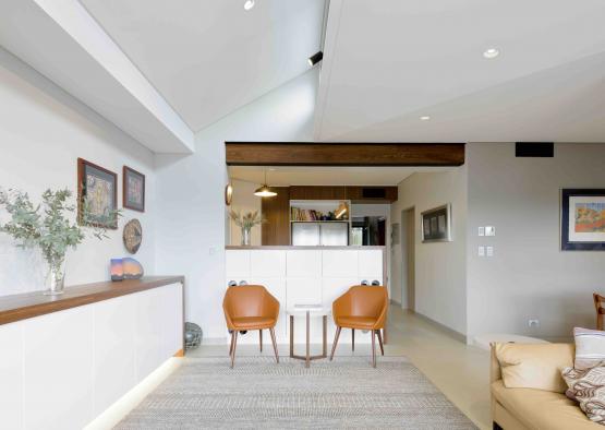 a room with a white cabinet and a table and chairs