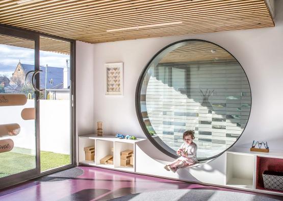 a child sitting in a round window