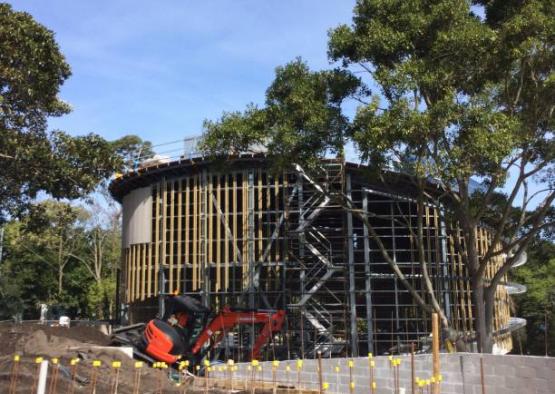 a building under construction with trees