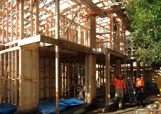 a construction site with people in orange vests