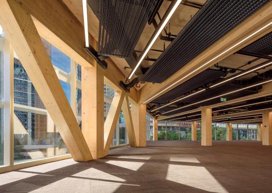 a large room with wooden beams and lights