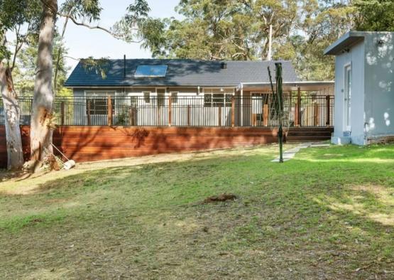 a house with a fence and grass