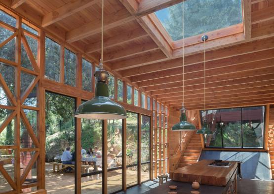 a room with a table and chairs and a large skylight