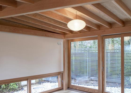 a room with a white wall and glass doors