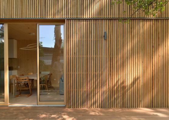 a wooden building with a glass door