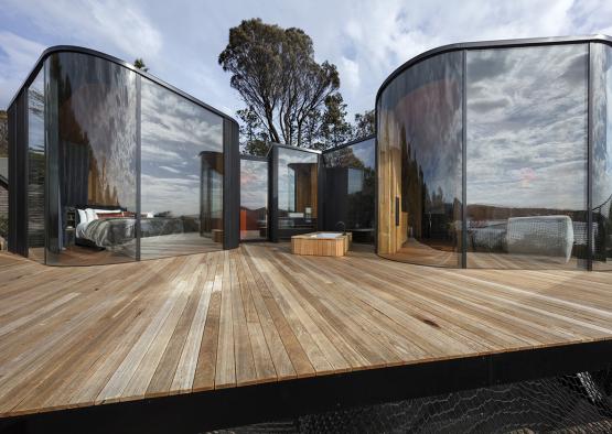 a glass building with a wooden deck