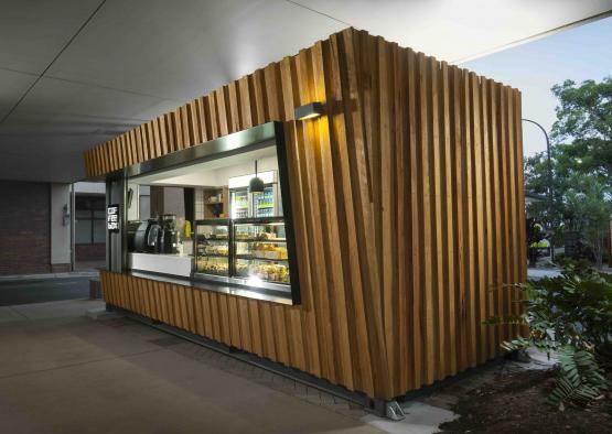 a small wooden building with a coffee shop