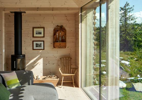 a living room with large windows and a couch