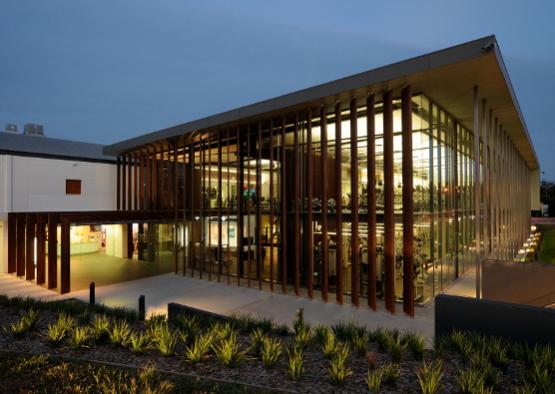 a building with glass walls and a walkway