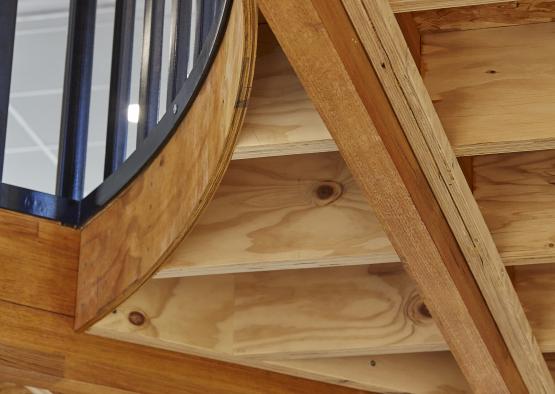 a wooden staircase with black railing