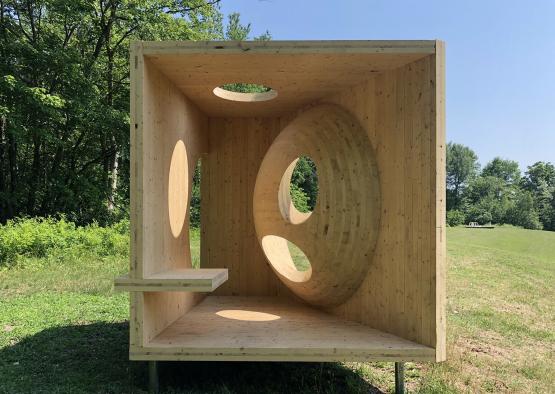 a wooden box with holes and a hole in the middle