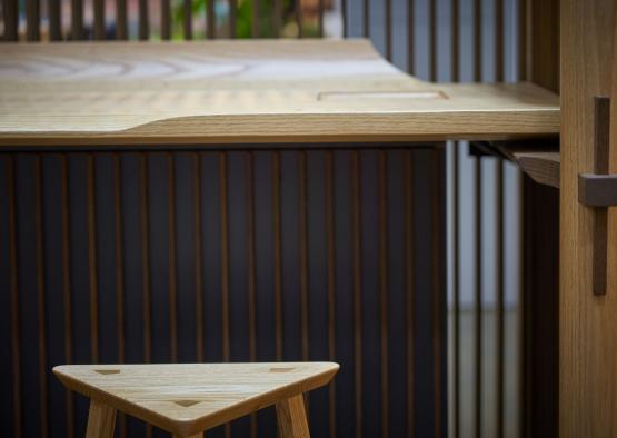 a wooden stool next to a table