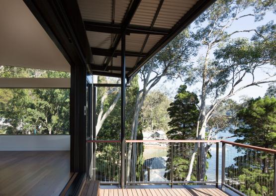 a deck with trees and water in the background