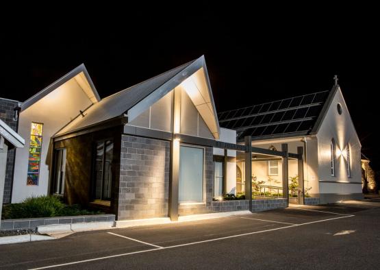 a building with a roof and a parking lot