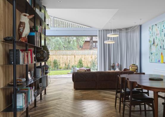 a living room with a couch and bookshelf