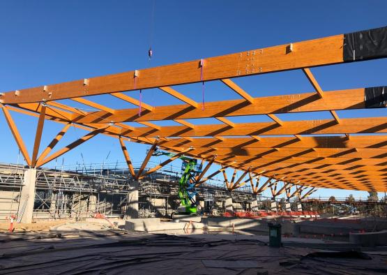 a construction site with a crane and a wooden structure