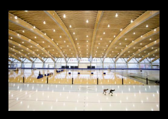 a large indoor ice rink with people skating