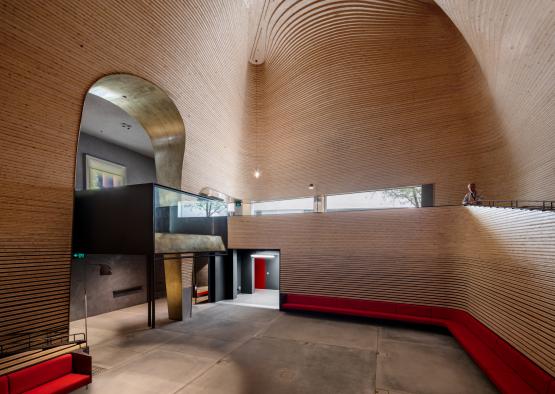 a large room with a red bench and a red bench