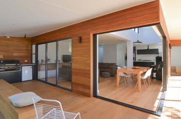 a room with a dining table and a kitchen