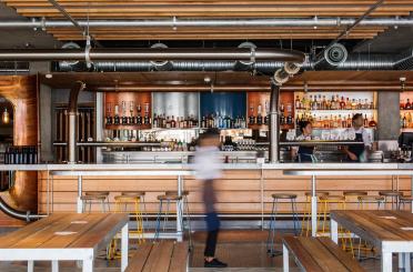 a bar with wooden benches and tables