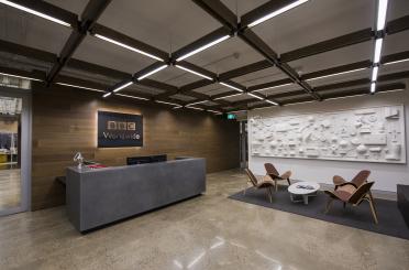 a reception desk and chairs in a building