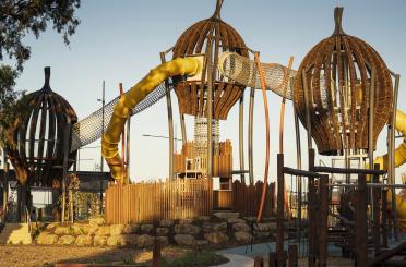 a playground with a yellow tube and a yellow tube