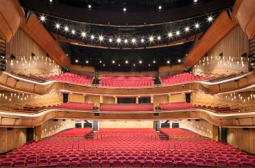 a large auditorium with red seats