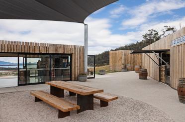 a picnic table and benches outside a building