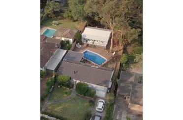 a house with a pool and a car in the back