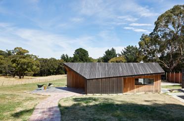 a building with a brick walkway and grass