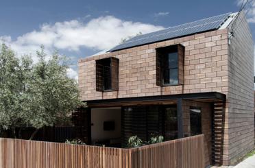 a house with a fence and a tree