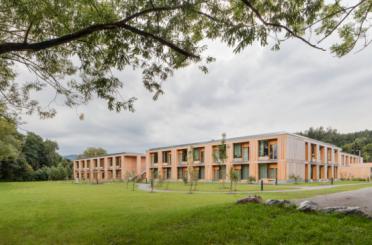 a building with many windows and grass