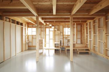 a room with wooden beams and stairs