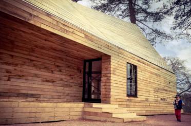 a wooden house with a door and steps