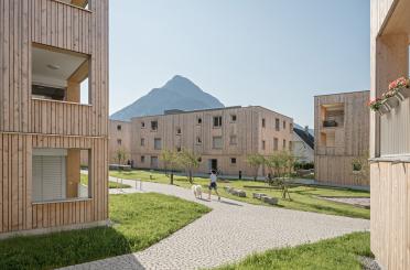 a group of buildings with grass and trees